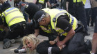 Police officers detain a woman during a protest in Nottingham.