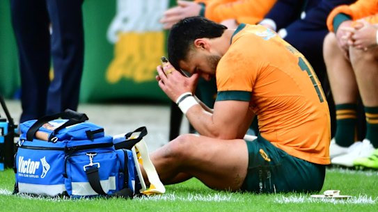 Tom Wright sitting on the sideline after coming off injured.
