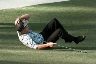 Greg Norman falls to the ground after missing his shot for an eagle at the 15th hole of the final round in 1996.