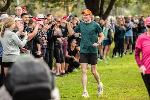 Richard Scolyer is cheered down the finishing chute at the Greenway Parkrun in Sydney’s inner west. 
