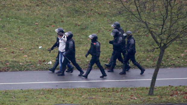 Belarusian riot police detain a demonstrator during an opposition rally to protest the official presidential election results in Minsk, Belarus.