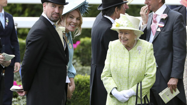 Loves her racing: Queen Elizabeth II right talks to her grandson, Peter Phillips, left and his wife, Autumn, during day five of Royal Ascot last weekend.