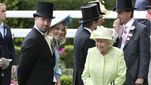 The Queen with her grandson Peter Phillips, left, and his wife Autumn in June last year.
