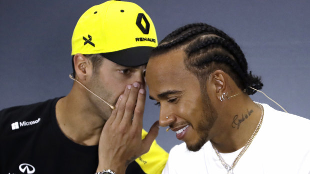 Renault driver Daniel Ricciardo chats with F1 championship leader Lewis Hamilton of Mercedes ahead of the British GP.