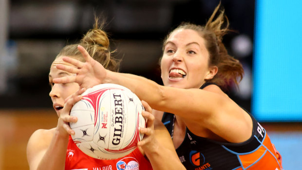 Maddie Hay of the Giants attempts to steal possession from Paige Hadley at Netball SA Stadium.