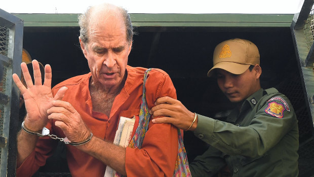 James Ricketson, who is accused of espionage, exits the prison van as he arrives at the Phnom Penh Municipal Court  for a court appearance.