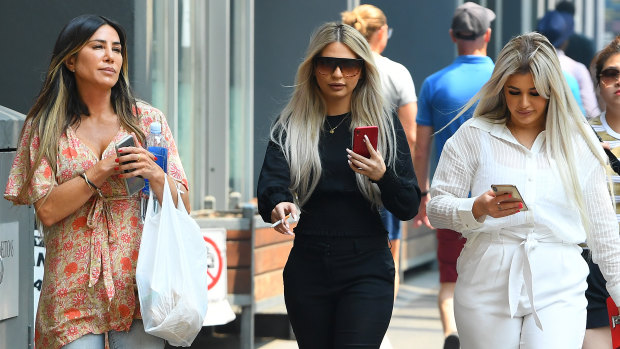 Brittany McGuire (right) and her friend Shanae Pericic (centre) arrive at Melbourne Magistrates Court on Tuesday.