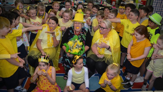 Jerrabomberra Public teachers Jane Taylor and Peta Kenningham with principal Chris Hunter (in hat) try the Lemon Face Challenge with students Maggie Coy, Grace Young and Ellie De Landre-Line.