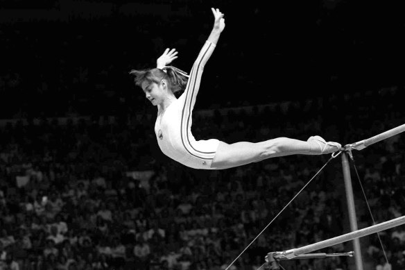 Nadia Comaneci, of Romania, dismounts from the uneven parallel bars during a perfect “10” performance at Montreal, 1976.