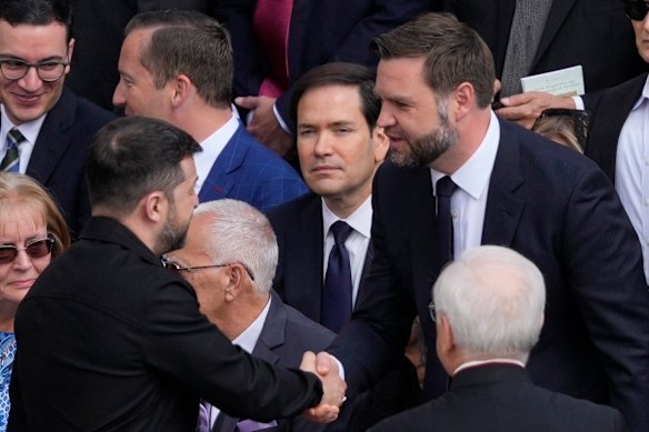 Ukraine’s President Volodymyr Zelensky, left, and US Vice President J.D. Vance greet each other as US Secretary of State Marco Rubio, centre, looks on. 