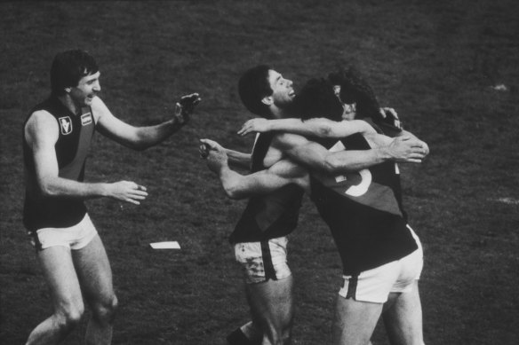 Essendon players celebrate after winning the 1984 grand final.