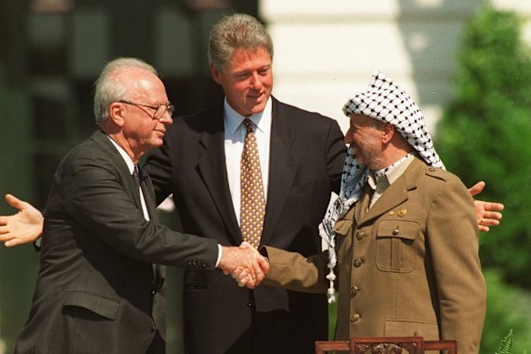 Israeli Prime Minister Yitzhak Rabin and Palestine Liberation Organisation chairman Yasser Arafat mark the signing of the first Oslo peace accord with a handshake at the White House in September 1993.