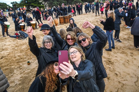 Women’s March 4 Justice in Torquay. Participants take a defiant selfie with fists raised.