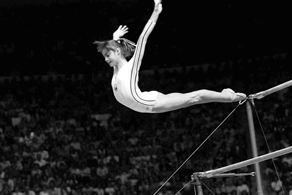 Nadia Comaneci, of Romania, dismounts from the uneven parallel bars during a perfect “10” performance at Montreal, 1976.