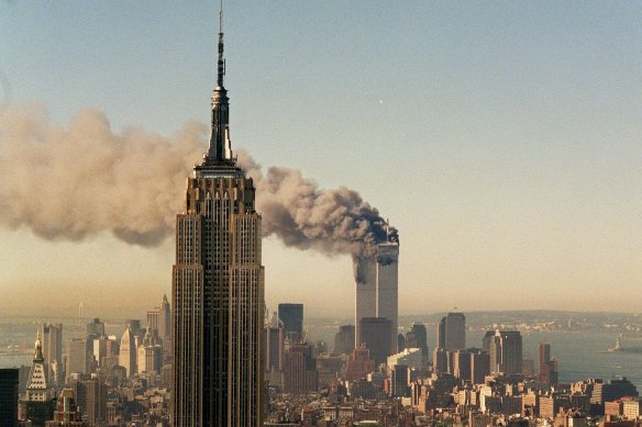 The twin towers of the World Trade Centre burn behind the Empire State Building in New York, after the terrorist attack of September 11, 2001.