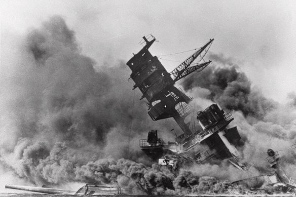 The USS Arizona belches smoke as it sinks into the sea during Japan’s surprise attack on Pearl Harbour in 1941.
