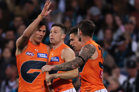 Toby Greene celebrates a goal with Giants teammates during the win over Port Adelaide.