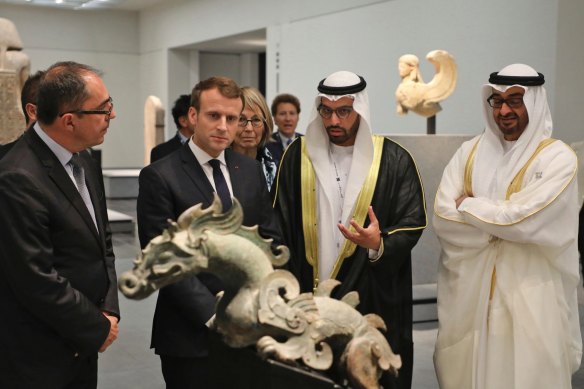 President-Director of the Louvre Museum Jean-Luc Martinez, left, French President Emmanuel Macron, second left, Chairman of Abu Dhabi’s Tourism and Culture Authority, Mohamed Khalifa al-Mubarak, second right, and Abu Dhabi Crown Prince Mohammed bin Zayed al-Nahayan, right, visit the Louvre Abu Dhabi Museum during its inauguration, November 8, 2017. 