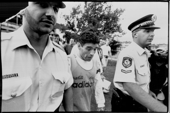 Maradona gets a police escort from training in Sydney in 1993.