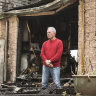 Jim Johnstone amid the burnt-out remains of his Sunbury home. 