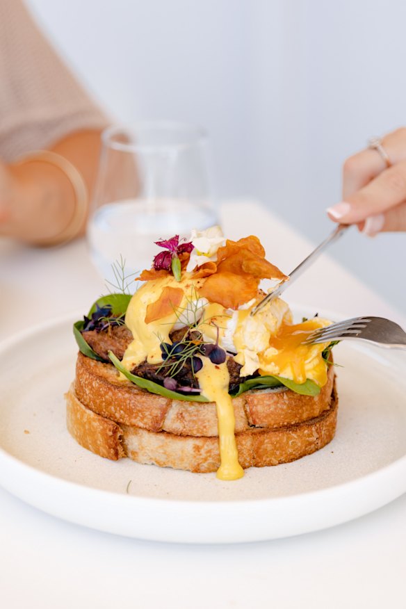 Eggs Benedict with fried sweet potato, beef brisket and poached eggs. 