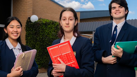 St Andrews College Marayong HSC students Caitlyn Dela Cruz and Cooper Shield have applied for early university offers. Nicola Gerardis (centre) plans to go into the workforce after completing year 12.
