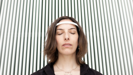 Natasha Schull, a cultural anthropologist and associate professor at MIT, demonstrates “Muse: the brain sensing headband” in Cambridge, Massachusetts in 2015.