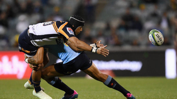 Back in the fold: Christian Lealiifano gets a pass away for the Brumbies despite the attention of Israel Folau. 