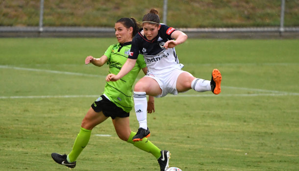 Victory's Annabel Beard flies above Ash Sykes at McKellar Park. 