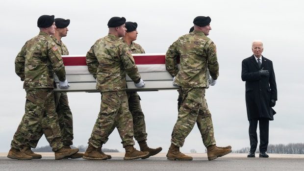 President Joe Biden stands as an army carry team moves the case containing the remains of 24-year-old Ladon Sanders.