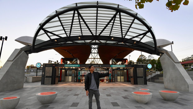 A commuter snaps a selfie outside Hills Showground station on the new Metro Northwest line. 