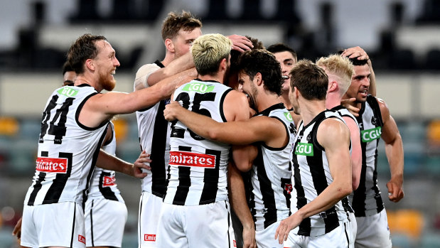 The Pies celebrate a goal. 