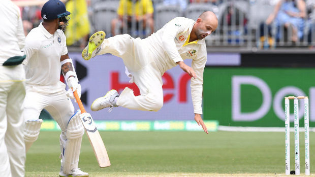 Up there: Nathan Lyon goes flying in a bid to reach a catching opportunity.
