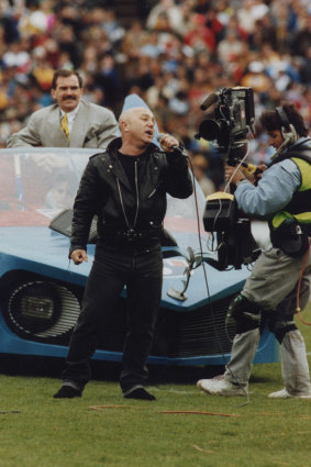 Angry Anderson with the Batmobile at the 1991 grand final.