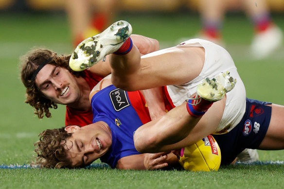 Luke Jackson comes to grips with the Brisbane Lions’ Deven Robertson.