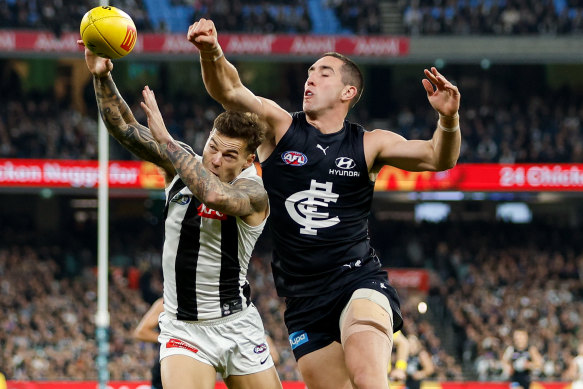 Jamie Elliott of the Magpies and Jacob Weitering of the Blues compete for the ball.