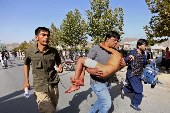 An injured boy is carried to a hospital after an explosion struck a protest by members of Afghanistan’s largely Shia Hazara ethnic minority group in 2016.