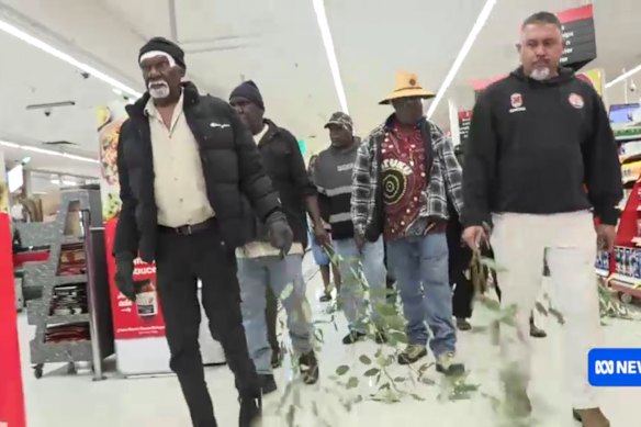 Mourners walk through the aisles of Coles in Alice Springs.