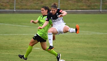 Victory's Annabel Beard flies above Ash Sykes at McKellar Park. 