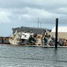 A vessel tipped on its side at Exmouth marina.