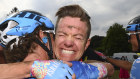 Stage winner Simon Clarke is congratulated by a teammate.