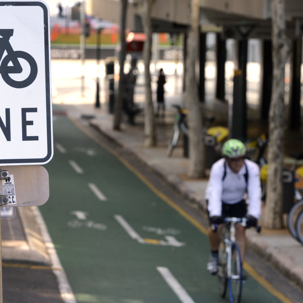 A cyclist rides his bike on a bike lane in Brisbane.