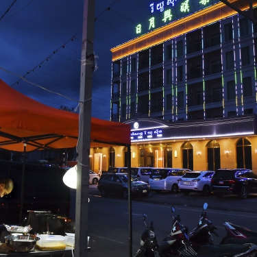 A Chinese food vendor cooks outside a Chinese casino in Sihanoukville.