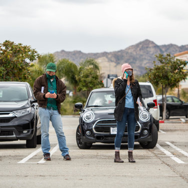 In California, people stand in a church carpark to wait for vaccines from a pop-up clinic in March. 