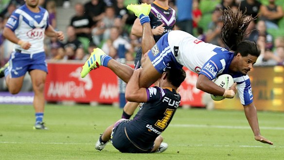 Brought down: Jayden Okunbor of Canterbury is tacked by Melbourne's Jahrome Hughes in last Sunday's game.