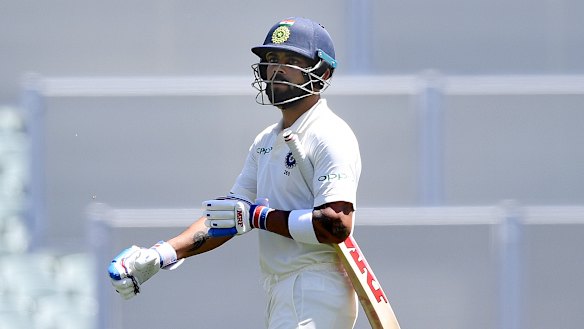 Virat Kohli leaves the field after Usman Khawaja took a brilliant catch to dismiss him.