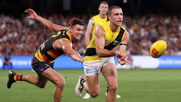 Jack Ross looks to evade Crows opponent Ben Keays in their round five clash.