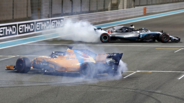 Departing F1 star Fernando Alonso and five-time world champion Lewis Hamilton burn rubber after the final grand prix of the season.