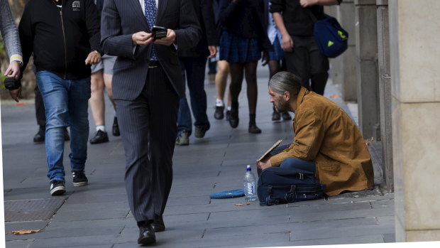 The haves and have not ... a man begs in Collins Street, Melbourne.
