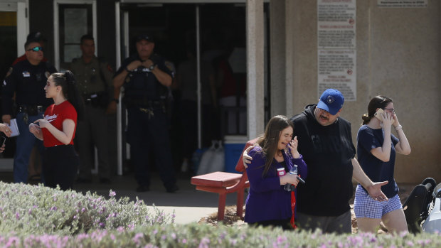 People arrive at MacArthur Elementary looking for family and friends as the school is being used a re-unification centre during the aftermath of a shooting at the Walmart in El Paso, Texas. 